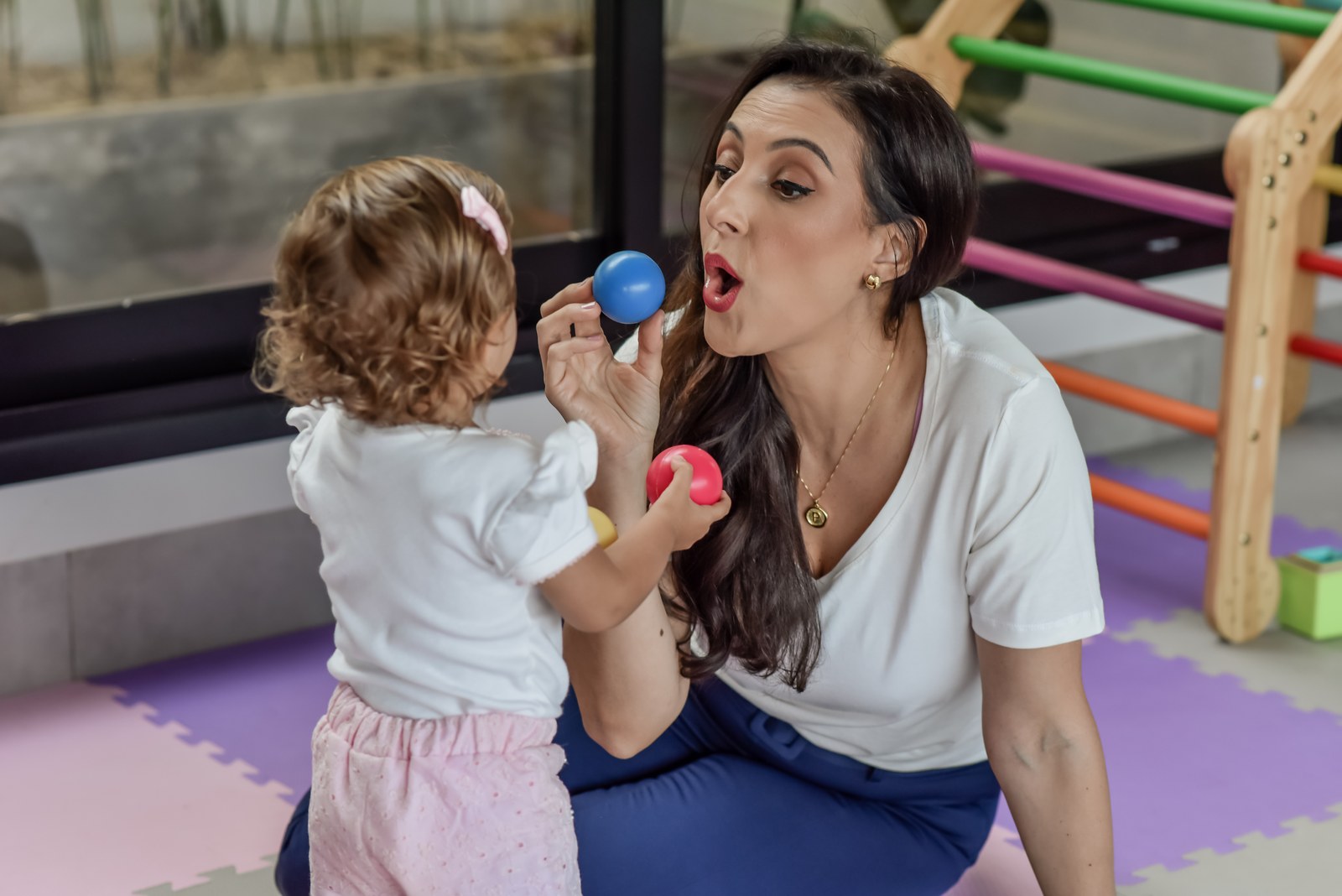 Paula Moura estimulando a fala de uma criança pequena